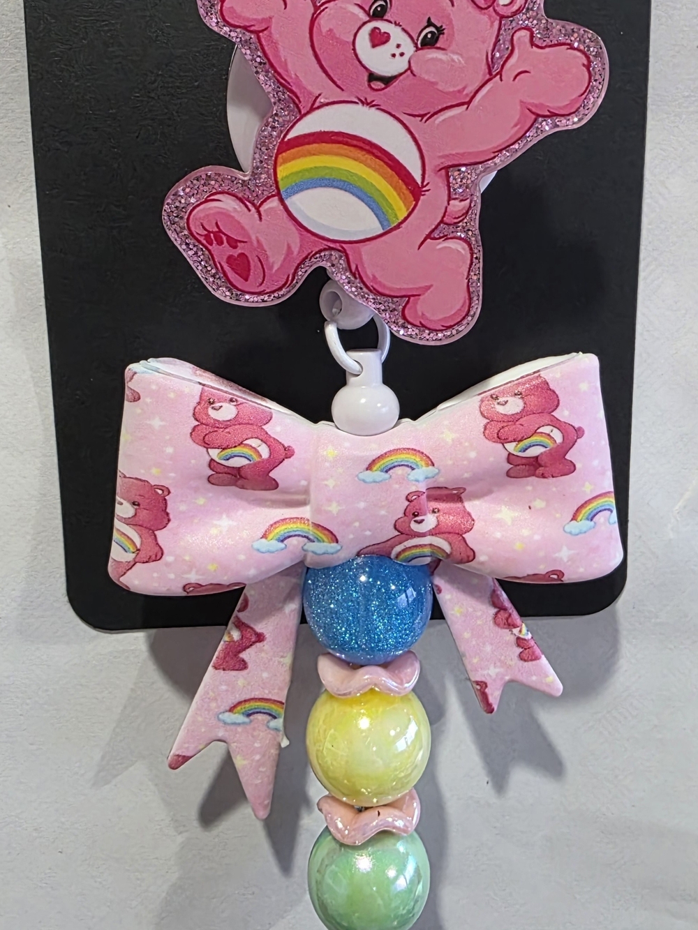 Care Bears Pink Rainbow Badge Reel  with Blue, Yellow & Green Beads